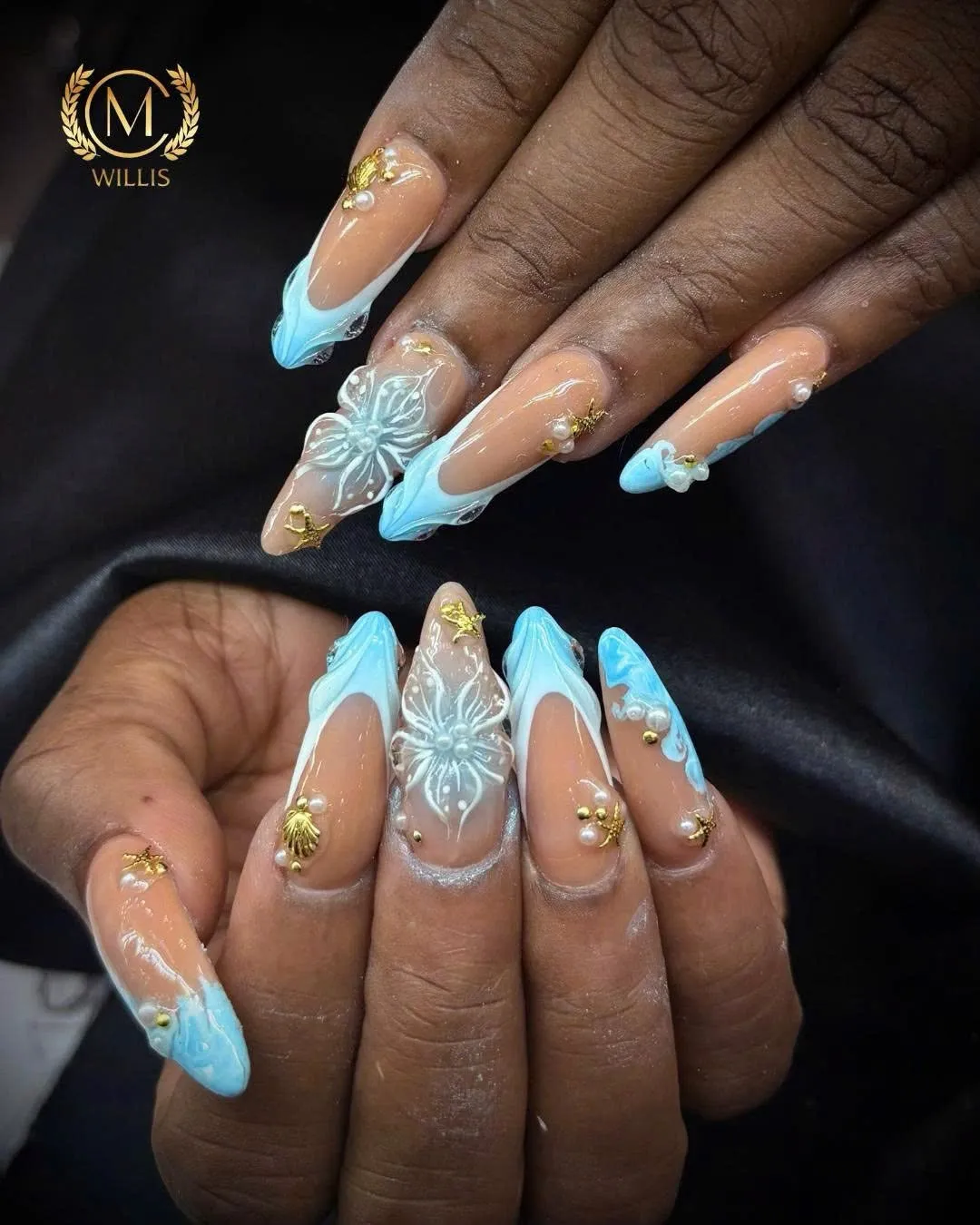 Long almond nails with baby blue French tips, 3D flowers and gold charms