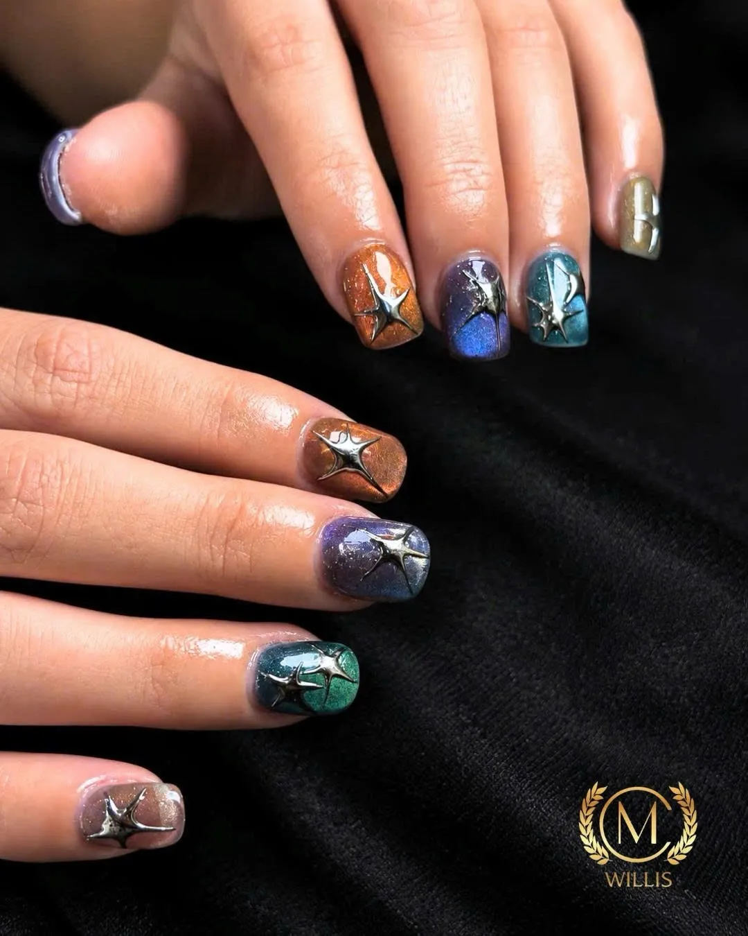 Short square nails in blue, teal and copper cat-eye galaxy finishes