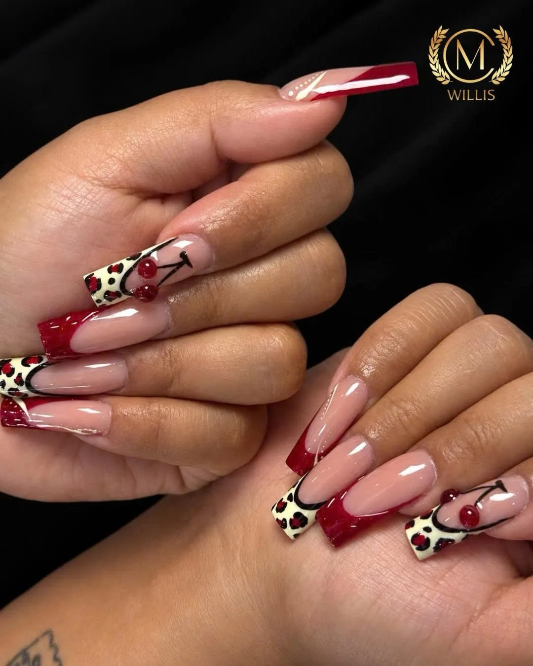 Square nails with deep red French tips, leopard print and hand-painted cherries