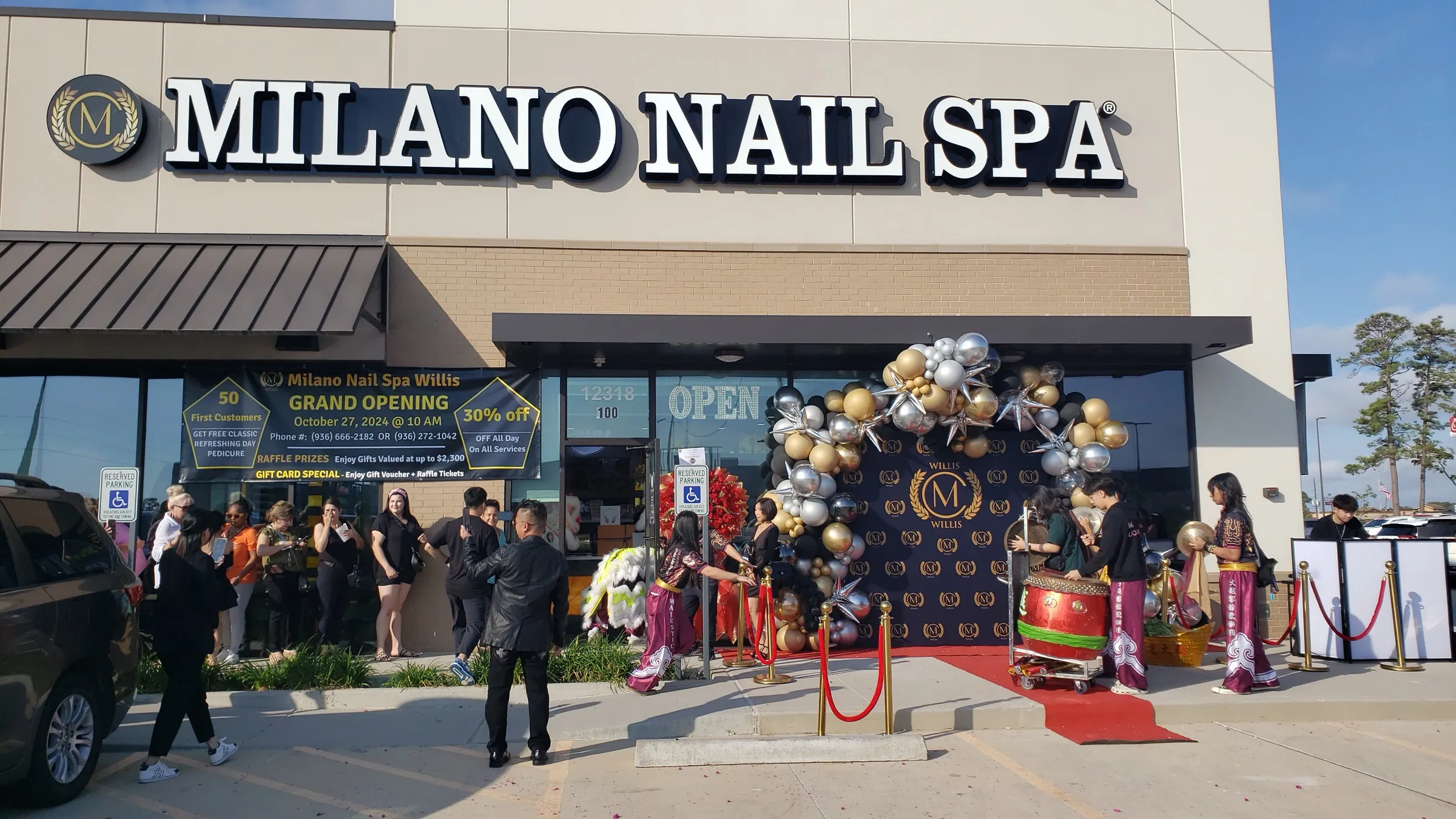 Milano Nail Spa Willis storefront on grand opening day with a gold and silver balloon arch