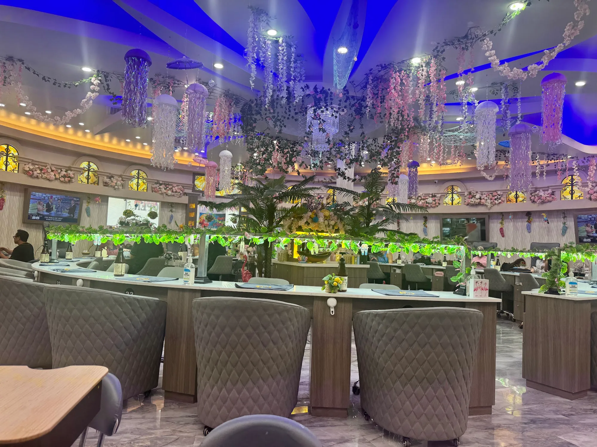 Manicure stations under the crystal chandeliers at Milano Nail Spa Willis