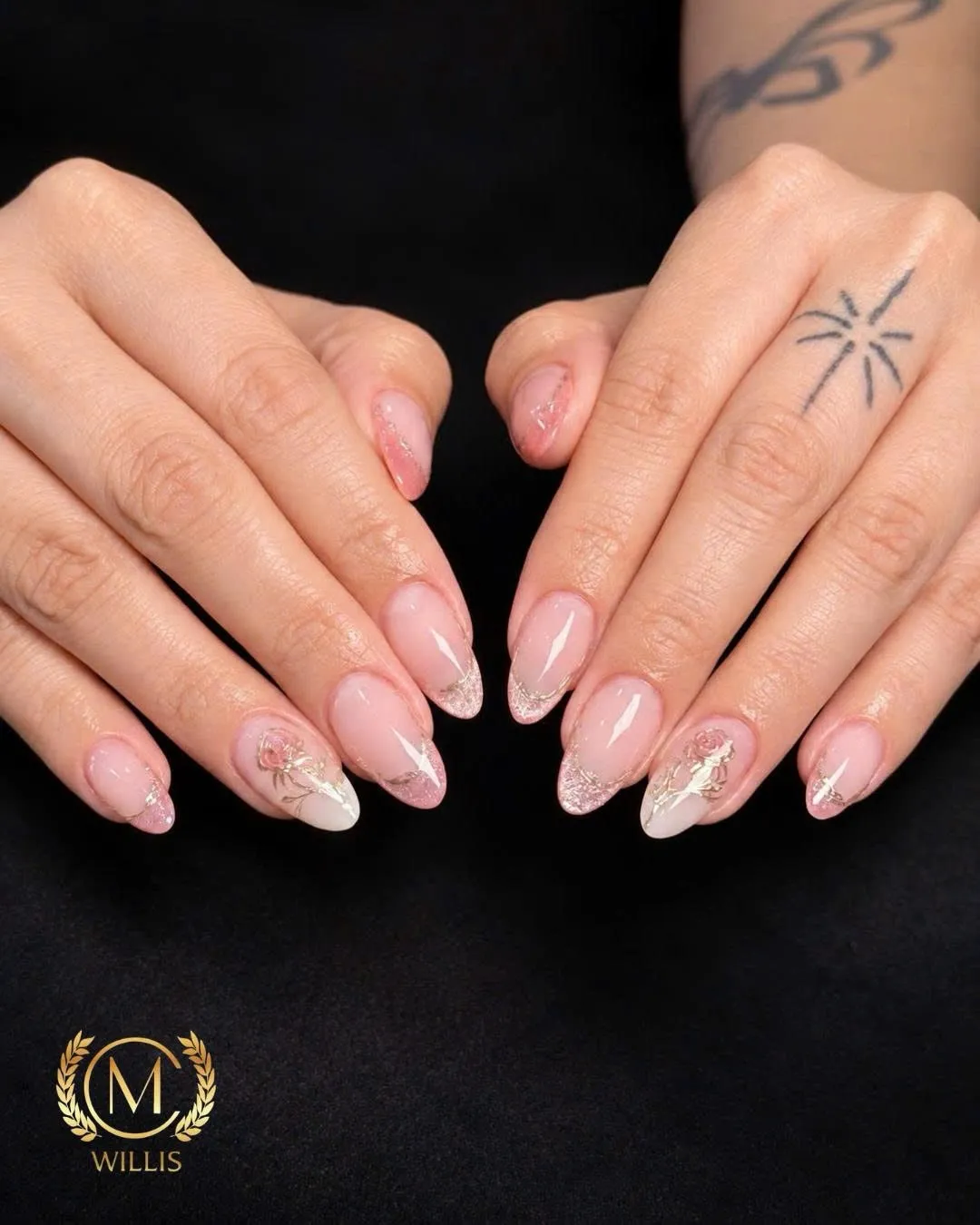 Sheer nude almond nails with gold foil and glitter accent nails