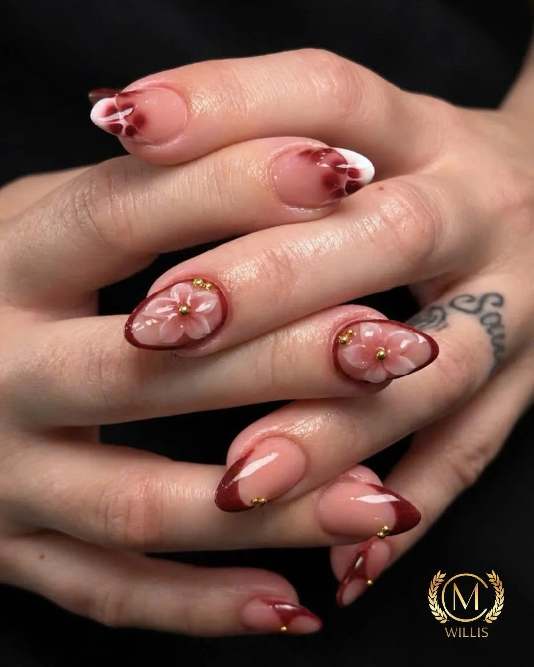 Almond nails with red French tips, 3D red flowers and gold studs
