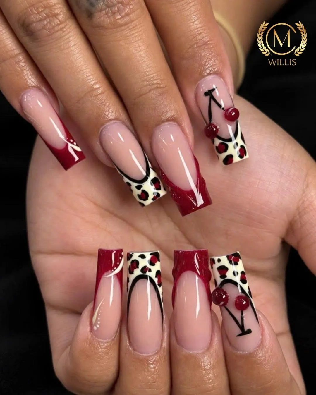 Long square nails with glossy red French tips, cream leopard tips and 3D cherries